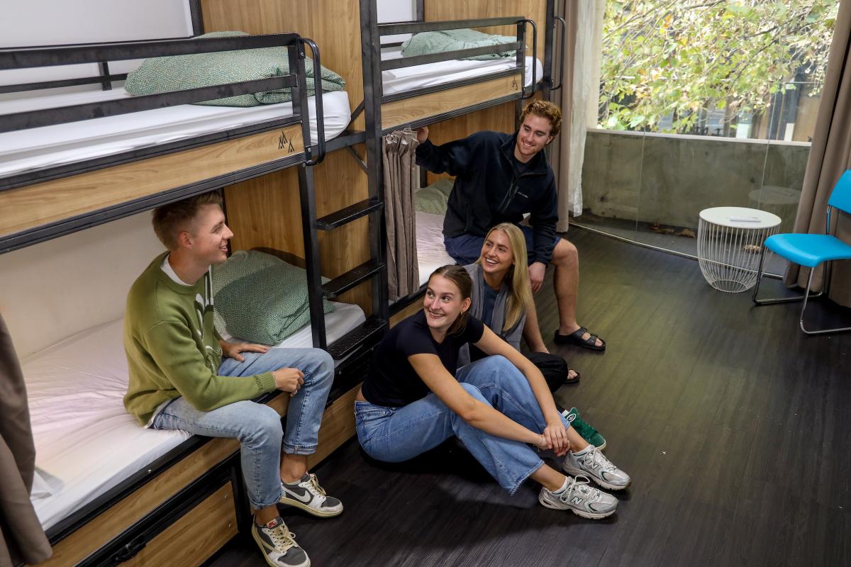 People sitting in a 4 bed dorm room in sydney hostel